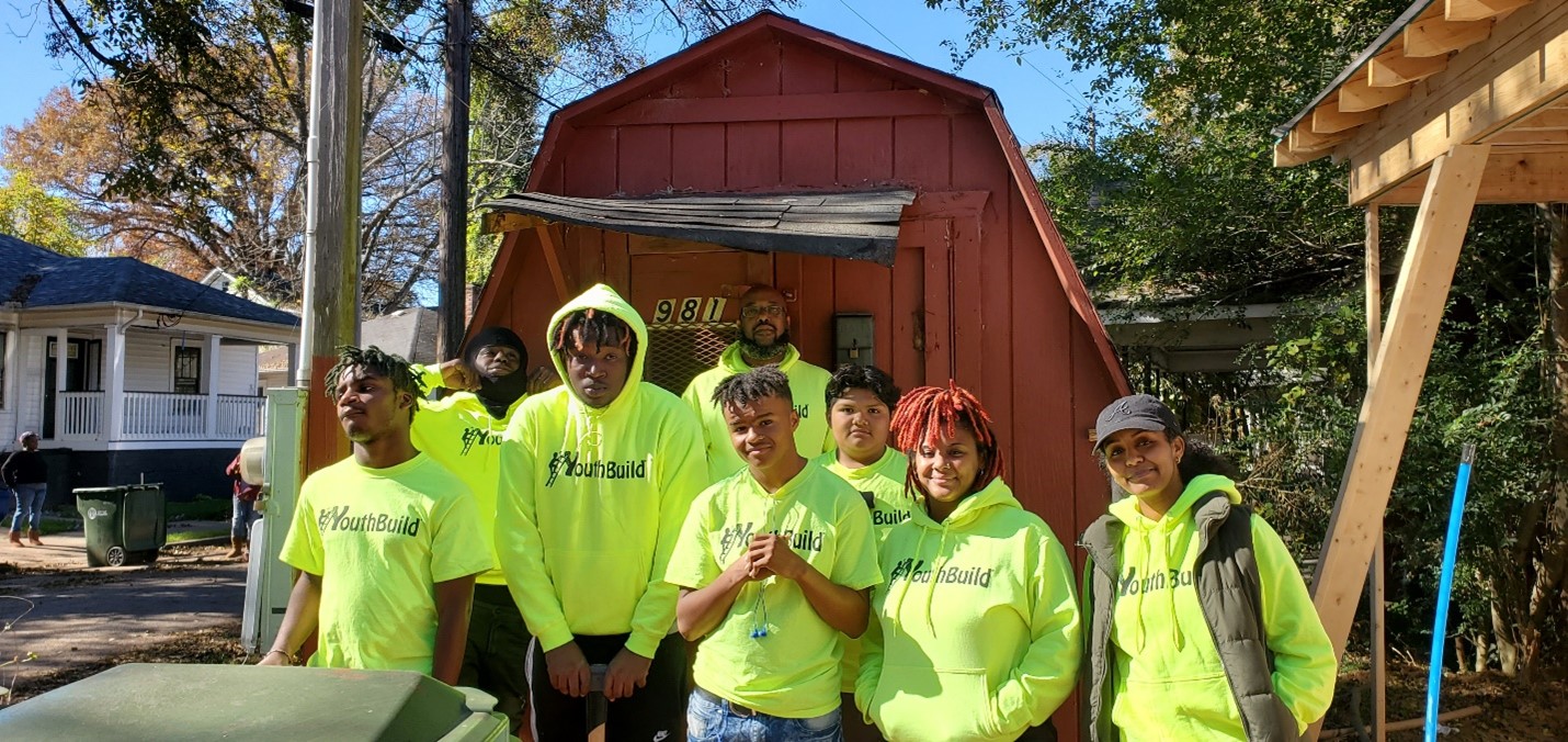 Helen Yohannes, far right, poses with YouthBuild 180 participants on a Westside job site.